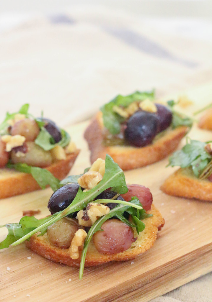 Rosemary roasted grapes on garlic crostini with wilted arugula and toasted walnuts.