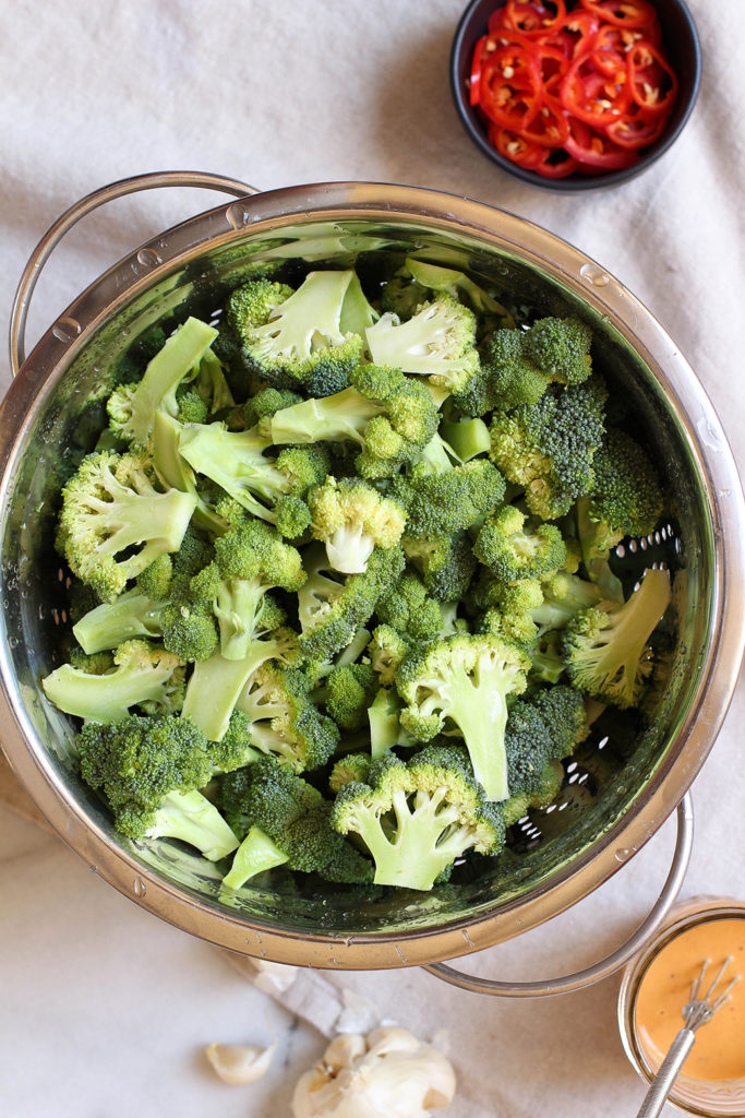 Spicy Broccoli Salad with peanut dressing and crispy garlic chips - vegan & gluten free