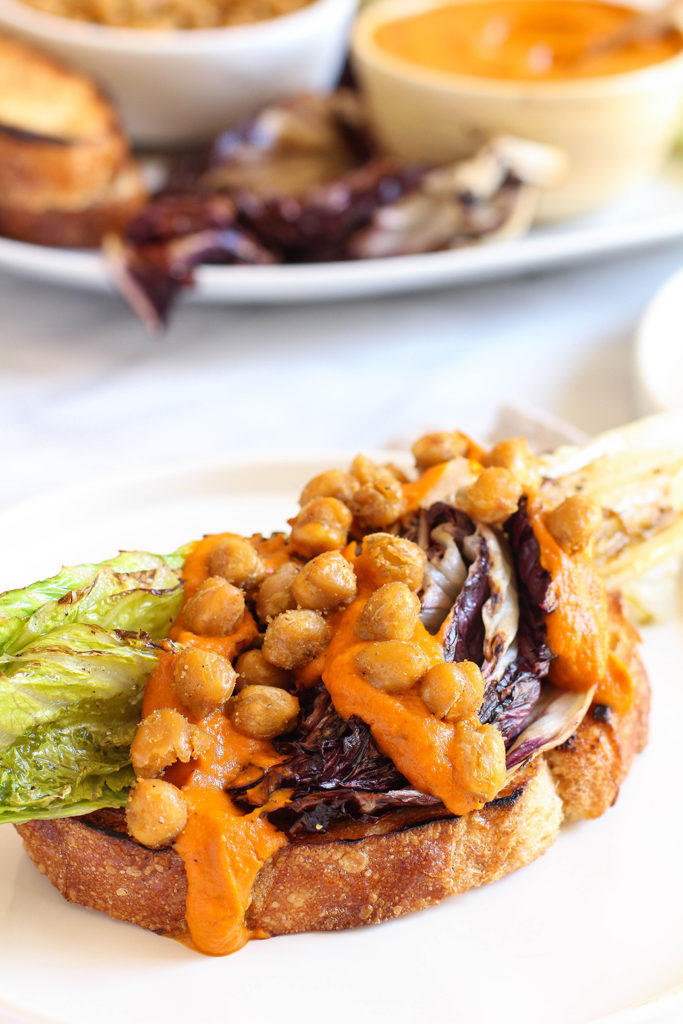 Grilled romaine & radicchio salad on sourdough with charred carrot dressing and crispy cumin spiced chickpeas